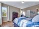 Comfortable bedroom with large windows, a wardrobe, and a cozy chair at 4000 Donnington Cir, Castle Rock, CO 80104