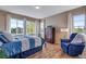 Bright bedroom with large windows, hardwood floors, and a cozy reading nook at 4000 Donnington Cir, Castle Rock, CO 80104
