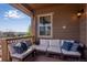 View of an outdoor deck with comfortable seating and a view of distant mountains at 4000 Donnington Cir, Castle Rock, CO 80104