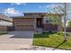 Home featuring a well-manicured lawn, a driveway, and an attached garage with paneled windows at 4000 Donnington Cir, Castle Rock, CO 80104