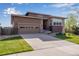 Beautiful home featuring a well-manicured lawn, a driveway, and an attached garage with paneled windows at 4000 Donnington Cir, Castle Rock, CO 80104