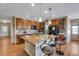 Spacious kitchen island with bar seating, granite counters, and wood cabinetry at 4000 Donnington Cir, Castle Rock, CO 80104