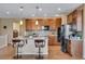Kitchen island features bar seating, pendant lights, and modern appliances at 4000 Donnington Cir, Castle Rock, CO 80104