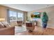 Cozy living room with hardwood floors, comfortable seating, and a modern TV at 4000 Donnington Cir, Castle Rock, CO 80104
