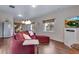 Comfortable living room featuring a red sofa, wood floors, and plenty of natural light at 4000 Donnington Cir, Castle Rock, CO 80104
