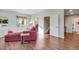 Bright living room boasting wood floors and a comfortable red sofa with staircase access at 4000 Donnington Cir, Castle Rock, CO 80104