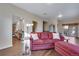 Inviting living room with a comfortable red sofa and access to kitchen and outdoor areas at 4000 Donnington Cir, Castle Rock, CO 80104