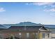 Beautiful mountain view seen from the roof of this house with trees and other homes at 4000 Donnington Cir, Castle Rock, CO 80104