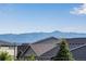 Beautiful mountain views from the roof of a house surrounded by lush trees and neighborhood homes at 4000 Donnington Cir, Castle Rock, CO 80104