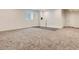 Unfinished basement featuring carpeted floors, neutral walls, and a window for natural light at 10197 E Mississippi Ave, Denver, CO 80247