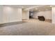 Spacious unfinished basement featuring neutral carpet, tile accents, and open layout at 10197 E Mississippi Ave, Denver, CO 80247