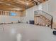 The basement has concrete floors, exposed wood framing, and a staircase to the upper level at 10197 E Mississippi Ave, Denver, CO 80247