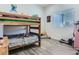 This bedroom has a cool bunk bed, gray floors, and a window to let in natural light at 10197 E Mississippi Ave, Denver, CO 80247