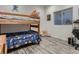 This cozy bedroom features a wooden bunk bed, gray floors, and great natural light at 10197 E Mississippi Ave, Denver, CO 80247