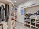 Open closet featuring custom shelving and ample storage space for clothes and accessories at 10197 E Mississippi Ave, Denver, CO 80247
