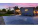Exterior elevation showcasing the home's architecture, driveway, and landscape lighting at 10197 E Mississippi Ave, Denver, CO 80247