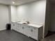 This kitchenette is efficiently designed with modern cabinetry and a sleek countertop at 10197 E Mississippi Ave, Denver, CO 80247