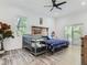 Bright main bedroom with light wood floors, high ceilings, and walkout deck access at 10197 E Mississippi Ave, Denver, CO 80247