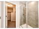 This bathroom features a glass shower and an open doorway to the walk-in closet at 16075 E Elk Pl, Denver, CO 80239