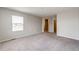 Bright bedroom featuring a window, plush carpet, and neutral paint, offering a serene and inviting space at 16075 E Elk Pl, Denver, CO 80239