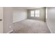 Bright, carpeted bedroom featuring multiple windows that let in natural light and neutral walls at 16075 E Elk Pl, Denver, CO 80239