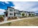 Modern townhome exterior featuring a landscaped front yard and contemporary architectural details at 16075 E Elk Pl, Denver, CO 80239