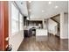 Open-concept kitchen featuring dark cabinets, stainless steel appliances, and hardwood flooring at 16075 E Elk Pl, Denver, CO 80239