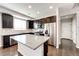 Spacious kitchen island with granite countertop, stainless steel appliances, and ample cabinet space at 16075 E Elk Pl, Denver, CO 80239