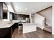 Modern kitchen with dark wood cabinets, stainless steel appliances, and granite countertops at 16075 E Elk Pl, Denver, CO 80239
