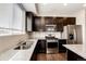 Well-lit kitchen with stainless steel appliances and granite countertops at 16075 E Elk Pl, Denver, CO 80239