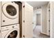 Convenient laundry area featuring stacked washer and dryer, maximizing space and efficiency at 16075 E Elk Pl, Denver, CO 80239