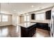 Bright, open-concept kitchen and living room area with hardwood floors and recessed lighting at 16075 E Elk Pl, Denver, CO 80239