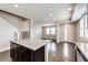 Open-concept living space with hardwood floors and a view of the entrance and stairway at 16075 E Elk Pl, Denver, CO 80239