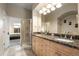 Bathroom with a double sink vanity with granite counters and a glass shower at 4001 W 32Nd Ave # 1, Denver, CO 80212
