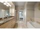 Bathroom with a double vanity, tub, and glass shower at 4001 W 32Nd Ave # 1, Denver, CO 80212