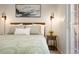 Bedroom with large bed, decorative pillows, sconces and door to outside at 4001 W 32Nd Ave # 1, Denver, CO 80212