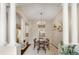 Dining room featuring an open floor plan with white pillars and neutral walls leading to the kitchen at 4001 W 32Nd Ave # 1, Denver, CO 80212