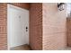 Close up of a white front door with a digital lock and a brick facade at 4001 W 32Nd Ave # 1, Denver, CO 80212
