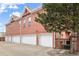 Red brick condos with attached garages and mature trees at 4001 W 32Nd Ave # 1, Denver, CO 80212