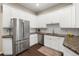 Beautiful kitchen with stainless steel appliances, granite countertops, and white cabinets with subway tile backsplash at 4001 W 32Nd Ave # 1, Denver, CO 80212