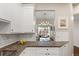 Kitchen featuring white cabinets with granite countertops and an open floor plan to the dining room at 4001 W 32Nd Ave # 1, Denver, CO 80212