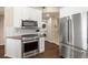 Kitchen featuring stainless steel appliances, white cabinets with granite countertops, and hardwood floors at 4001 W 32Nd Ave # 1, Denver, CO 80212
