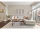Spacious living room with a large couch, wood floors, and a glass sliding door to a private patio at 4001 W 32Nd Ave # 1, Denver, CO 80212