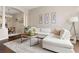Bright living room features a large sectional, stylish decor, and hardwood floors with neutral walls at 4001 W 32Nd Ave # 1, Denver, CO 80212