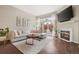 Bright living room with a comfortable couch, a fireplace, wood floors, and a glass sliding door to a private patio at 4001 W 32Nd Ave # 1, Denver, CO 80212