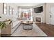 Inviting living room with a large couch, wood floors, and a glass sliding door to a private patio at 4001 W 32Nd Ave # 1, Denver, CO 80212