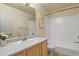 A well-lit bathroom with tile floors, a vanity, mirror, and a bathtub-shower combination at 21422 E 47Th Ave, Denver, CO 80249