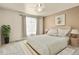 Cozy bedroom featuring a ceiling fan and a large window for plenty of natural light at 21422 E 47Th Ave, Denver, CO 80249