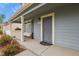 Charming entry of home featuring covered porch, neat landscaping, and natural light at 21422 E 47Th Ave, Denver, CO 80249