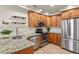 Well-equipped kitchen with stainless steel appliances and granite countertops at 21422 E 47Th Ave, Denver, CO 80249